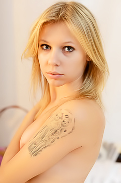 Young blond girl with tattoo